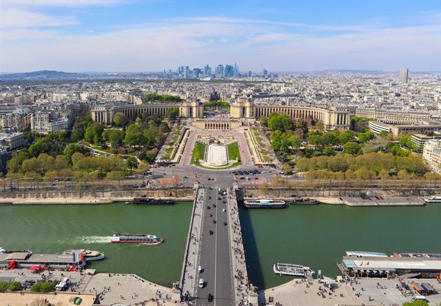Aerial view over the Seine bridge and Trocadero gardens toward the La Defense towers