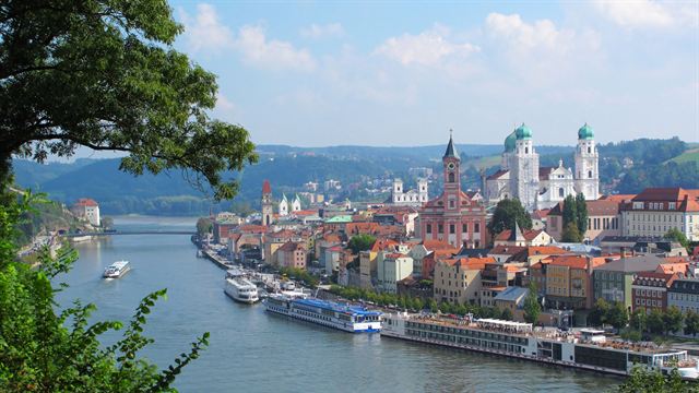 Passau old town and St. Stephen's Cathedral domes with river cruise ships moored below