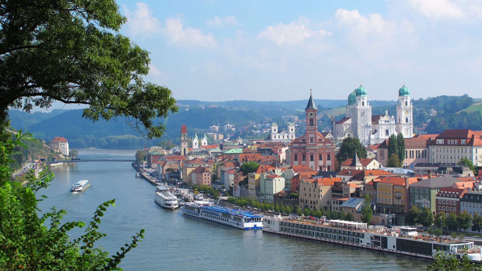 Passau old town and St. Stephen's Cathedral domes with river cruise ships moored below