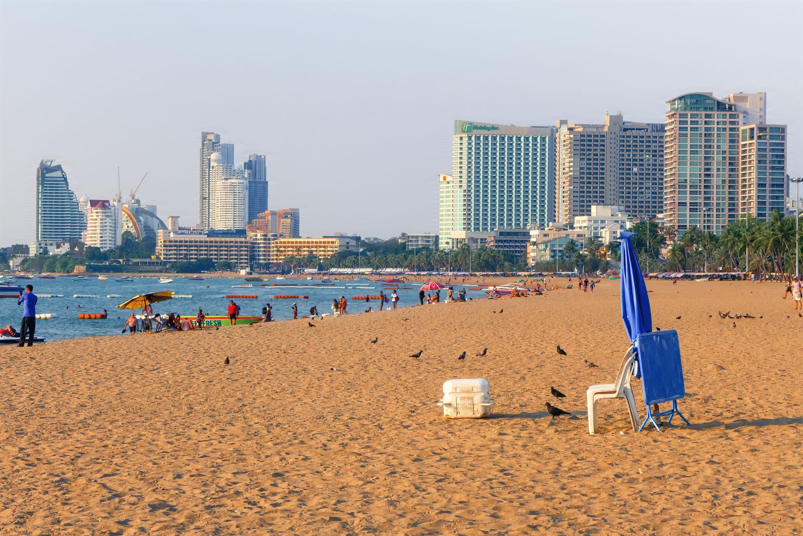Pattaya Beach's golden sand with umbrellas and the city's high-rise hotel skyline behind