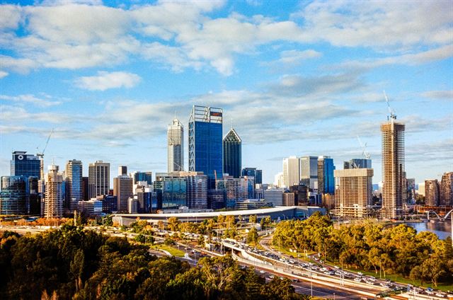 Perth CBD skyline with the Swan River foreshore and freeway seen from Kings Park under blue sky