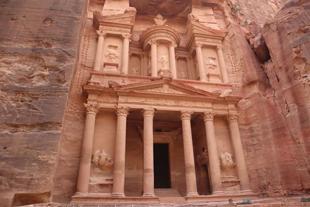 The rock-cut Al-Khazneh Treasury facade carved into rose-red sandstone cliffs at Petra, Jordan