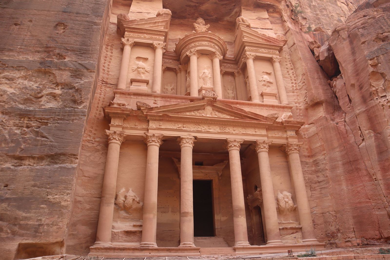 The rock-cut Al-Khazneh Treasury facade carved into rose-red sandstone cliffs at Petra, Jordan
