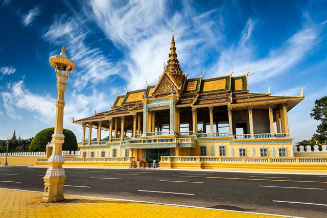 Moonlight Pavilion of the Royal Palace in Phnom Penh with golden spires and yellow walls