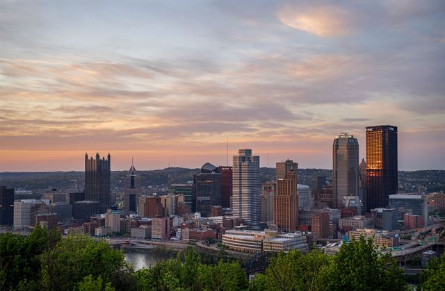 Pittsburgh downtown skyscrapers and Golden Triangle seen from a hillside overlook at sunset
