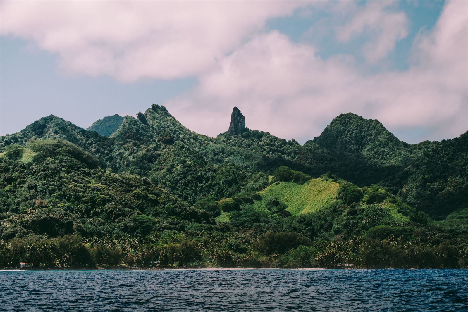 Rarotonga's jungle-covered volcanic interior with the spike of Te Rua Manga (The Needle) seen from the sea
