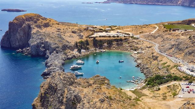 Aerial view of St Paul's Bay at Lindos on Rhodes, a turquoise lagoon enclosed by rocky headlands