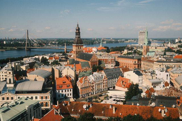 Aerial view of Riga Old Town rooftops, Riga Cathedral tower and the Daugava River with Vansu Bridge