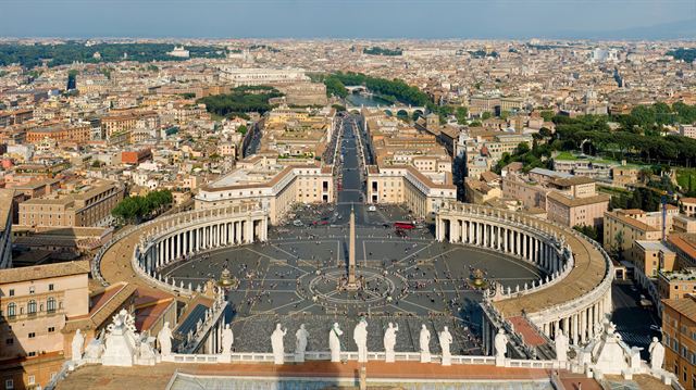 St. Peter's Square in Vatican City seen from above, with Rome's rooftops beyond