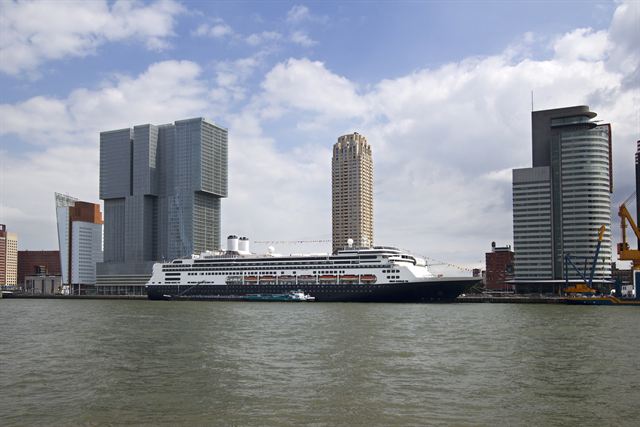 Holland America cruise ship moored in front of De Rotterdam and other Rotterdam towers