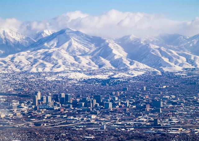 Downtown Salt Lake City below the snow-covered Wasatch Range on a bright winter day