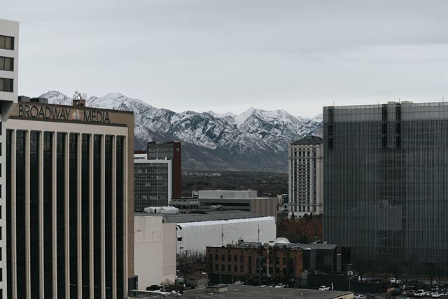 Downtown Salt Lake City office buildings with snow-capped Wasatch peaks rising behind