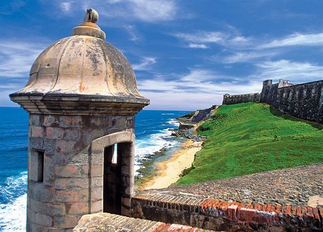 Stone sentry box (garita) on El Morro's ramparts overlooking the green lawn and Atlantic surf, San Juan