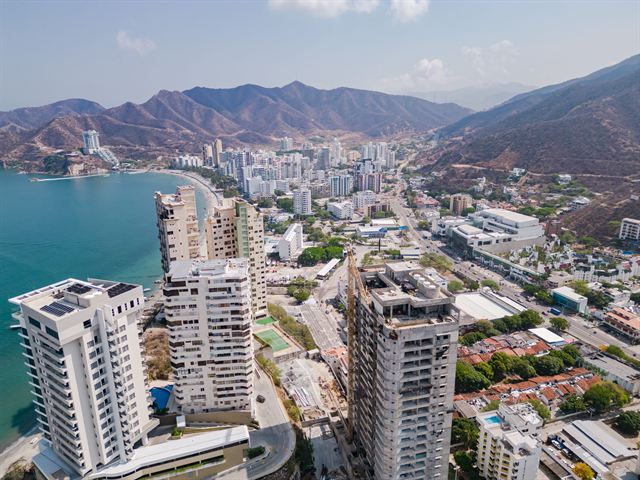 Drone view over Santa Marta high-rises, bay and dry mountains in Colombia