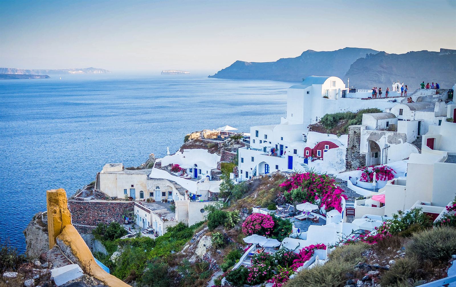 Whitewashed houses and bougainvillea on the Santorini caldera cliffs