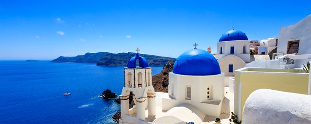 Whitewashed cliffside houses of Santorini perched on the caldera rim above the deep blue Aegean