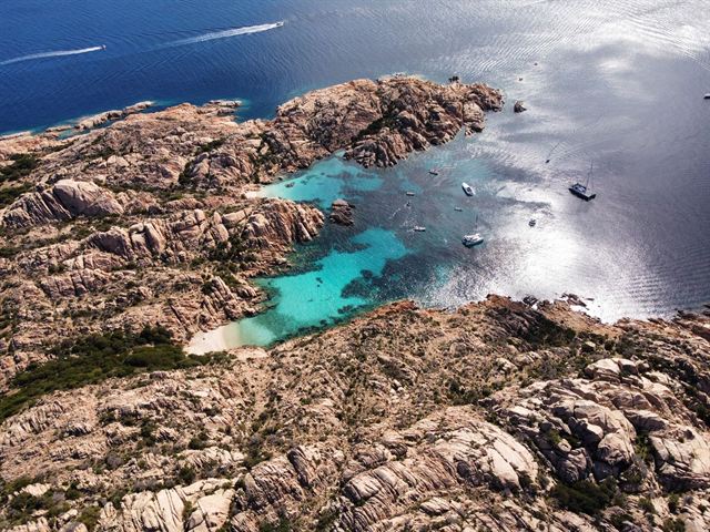 Aerial view of turquoise coves and pink granite rocks in the La Maddalena archipelago, Sardinia