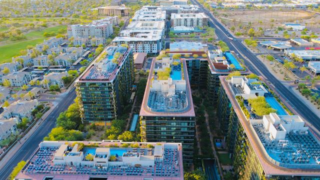 Aerial view of Scottsdale, Arizona with modern mid-rise apartments, rooftop pools and desert streets
