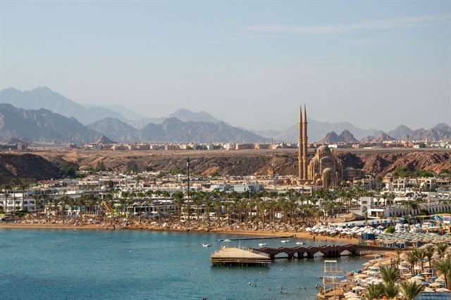 Sharm El Maya bay in Sharm El Sheikh with beach, hotels, Al Sahaba Mosque and Sinai mountains