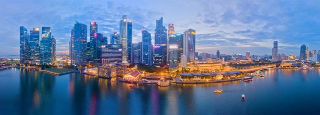 Singapore downtown skyline across Marina Bay at dusk