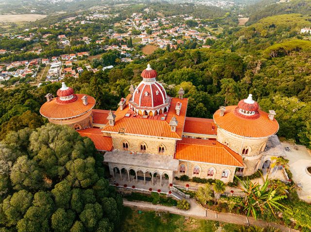 Aerial view of Monserrate Palace in Sintra with its red dome among lush forest