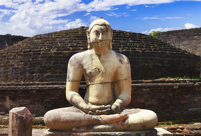 Seated stone Buddha statue at the ancient city of Polonnaruwa, Sri Lanka