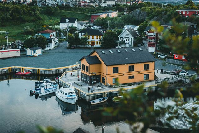 Aerial view of Quidi Vidi village harbour in St. John's with boats, wharves and colorful wooden houses
