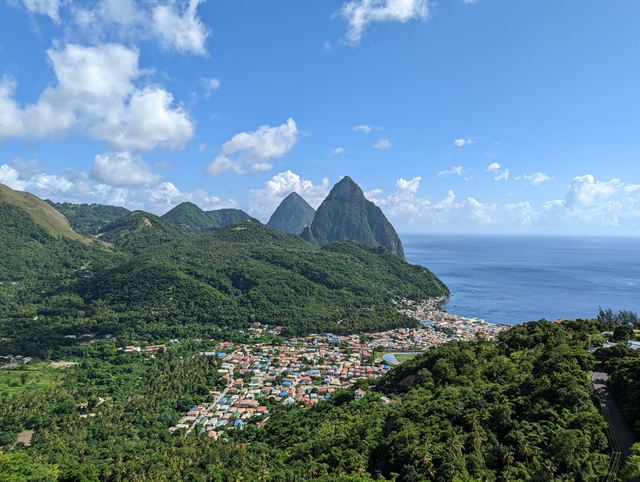 Gros Piton and Petit Piton towering over the colorful rooftops of Soufriere and the Caribbean Sea, Saint Lucia