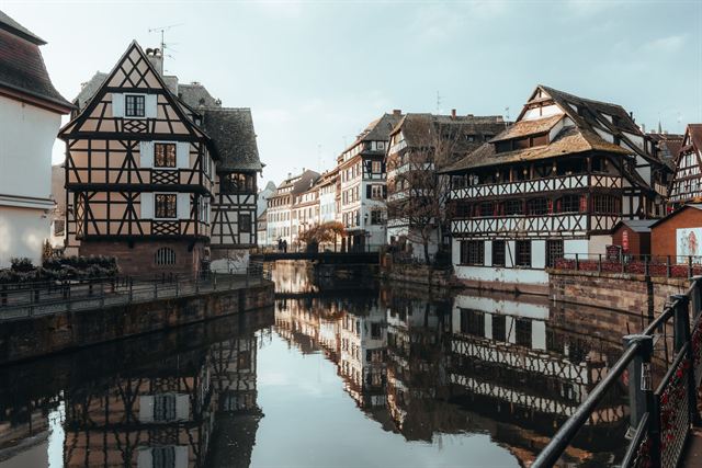 Petite France quarter in Strasbourg, half-timbered houses mirrored in a still canal