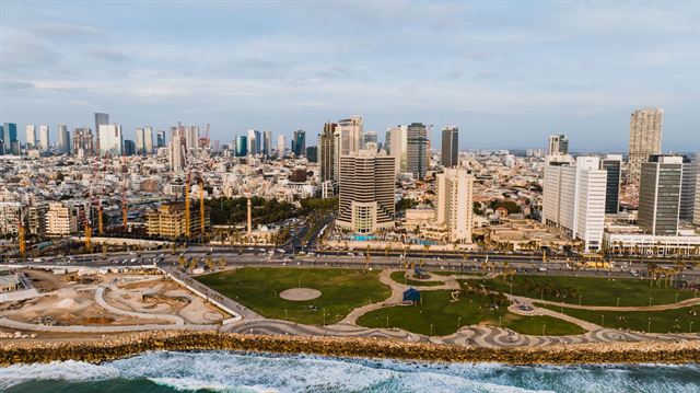 Aerial view of Tel Aviv high-rises, a seaside park and the Mediterranean shoreline