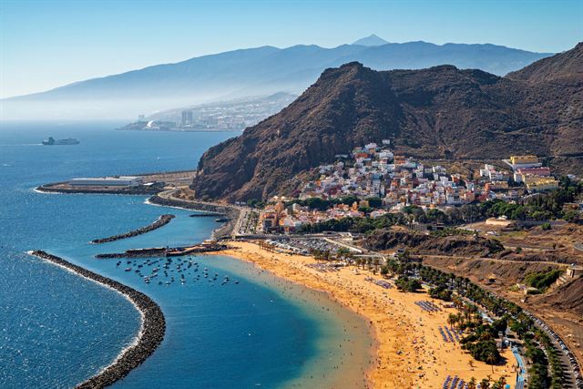 Aerial view of Playa de Las Teresitas golden beach, breakwaters and San Andres village in Tenerife