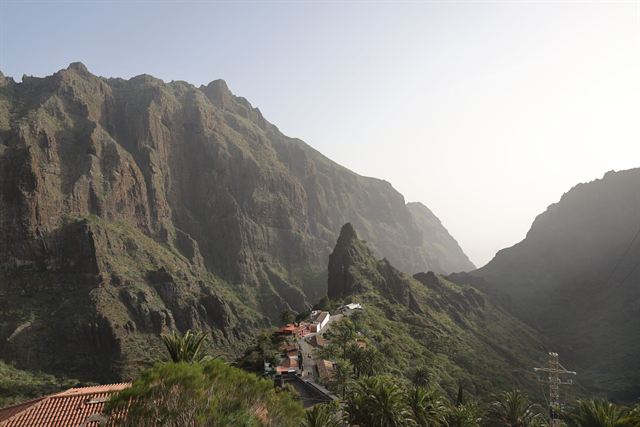 Steep jagged mountains of the Masca Valley in Tenerife with a village perched on a ridge