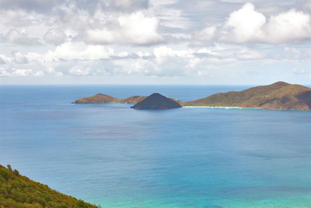 View from a Tortola hillside over turquoise water toward small islands in the British Virgin Islands