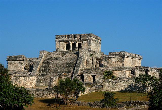 El Castillo, the main stone Maya temple at the Tulum ruins, under blue sky