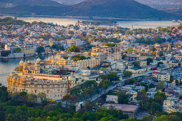 Aerial view of Udaipur with the City Palace, Lake Pichola and the old city below the Aravalli hills