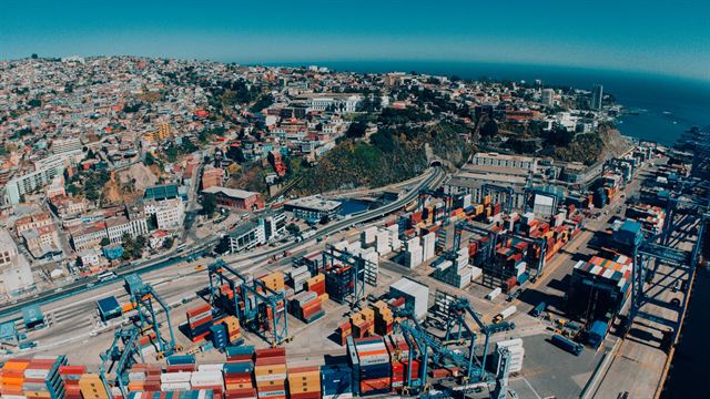 Wide aerial view of Valparaiso hills, container port and harbor on the Chilean Pacific coast