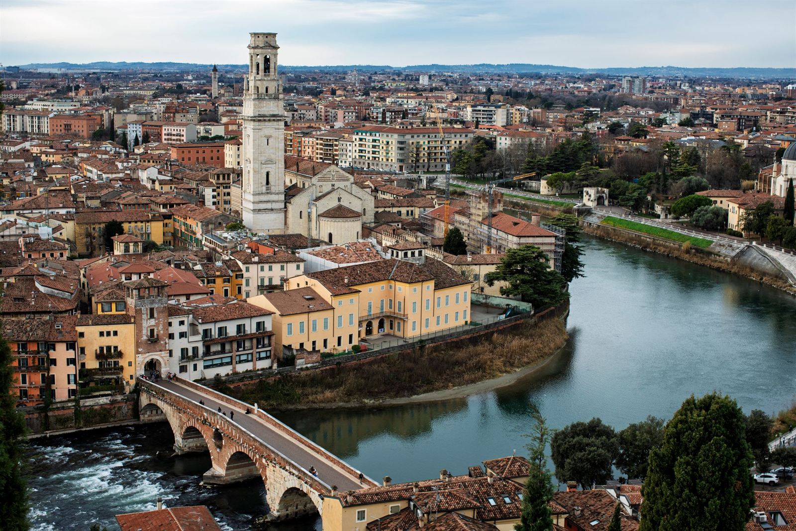 Elevated view of Verona with the Adige River bend, Roman Ponte Pietra bridge and cathedral bell tower