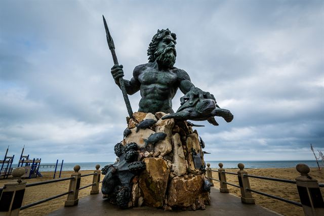 King Neptune bronze statue at the Virginia Beach oceanfront under grey skies