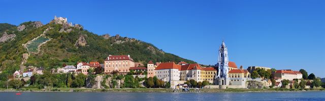 Durnstein village, blue abbey tower and castle ruin on the hill above the Danube