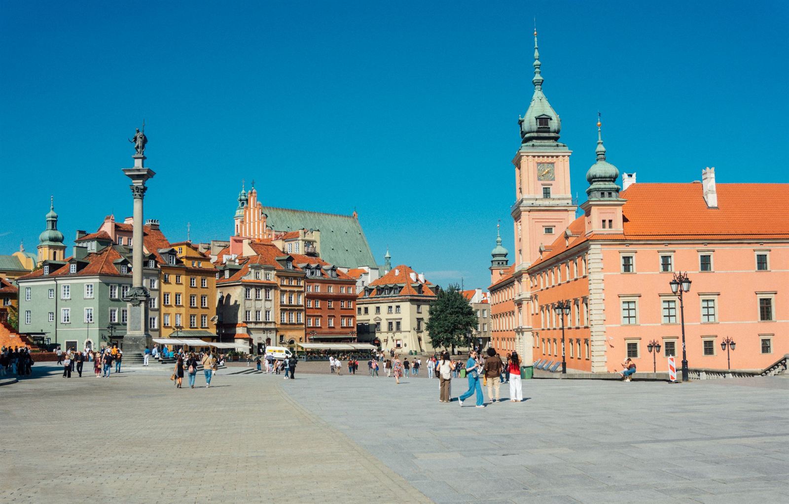 Warsaw Old Town Castle Square with Sigismund's Column, the Royal Castle clock tower and colorful townhouses