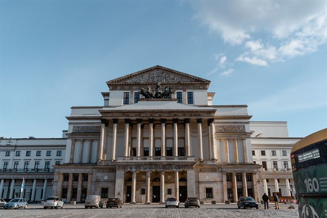 Neoclassical colonnaded facade of the Grand Theatre (Teatr Wielki) in Warsaw under blue sky