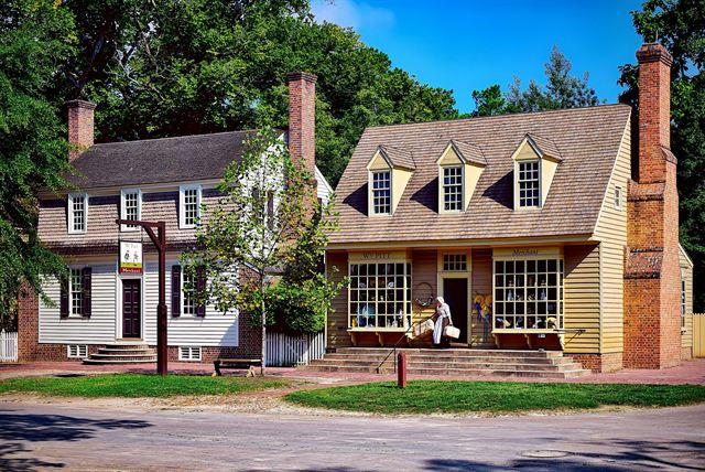 Restored colonial clapboard shops and houses along a street in Colonial Williamsburg, Virginia
