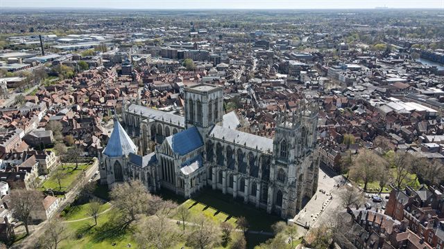 Aerial view of York Minster cathedral surrounded by the rooftops of York city