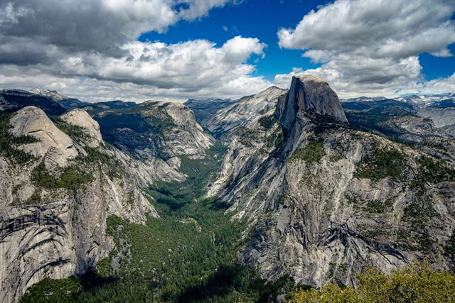 Half Dome and Yosemite Valley seen from Glacier Point under dramatic clouds