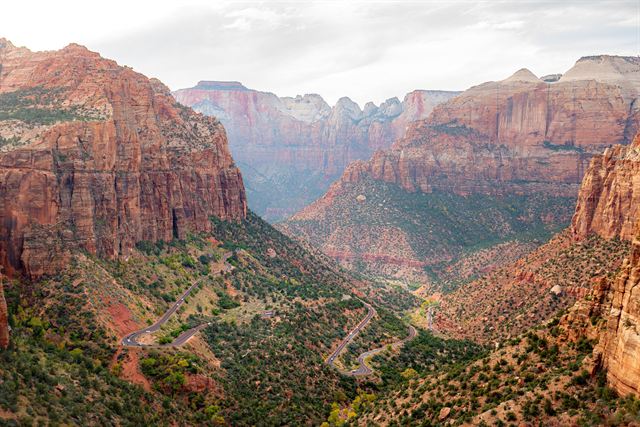 Zion-Mount Carmel Highway switchbacks climbing a red-rock canyon between sheer cliffs in Zion