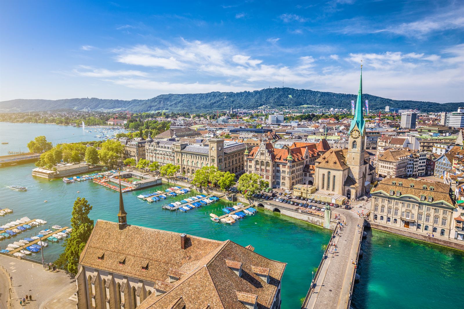 Aerial view of Zurich old town along the Limmat river with the Fraumünster spire and the lake beyond